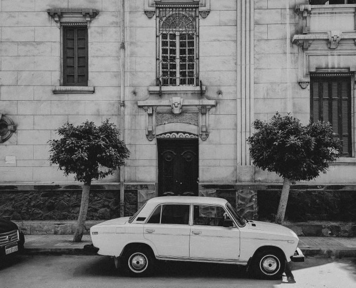 an old car in front of an old building