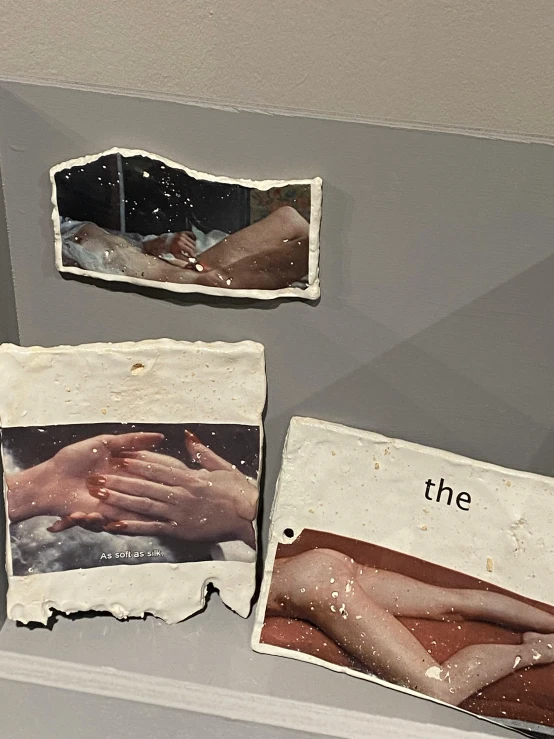 various paintings of hands touching each other on a wall