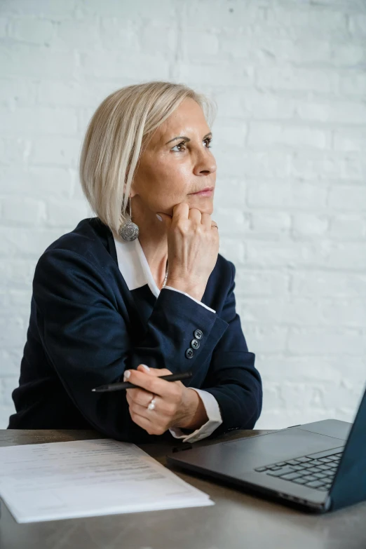 a woman sitting in front of a laptop computer