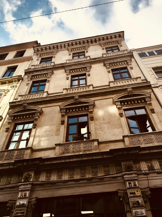 an old building with lots of windows and a clock on it