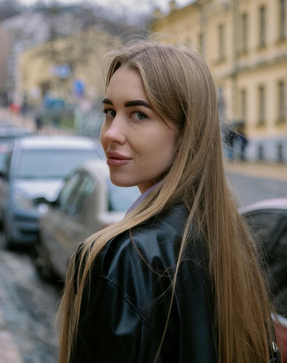 woman in black jacket standing in middle of street