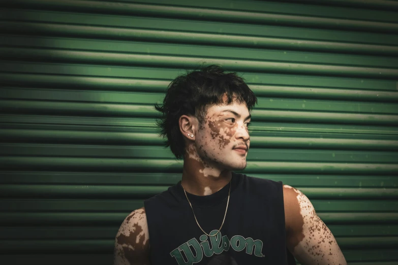 a man is posing for a po with freckles on his body