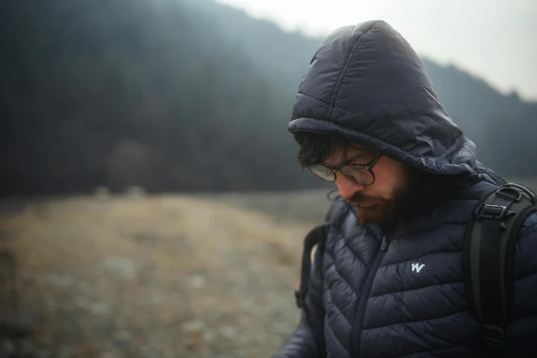 a person with a beard and glasses on and wearing a jacket