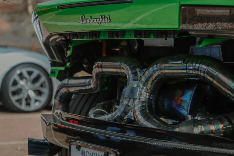 a large green truck with exhaust pipe coming out the back