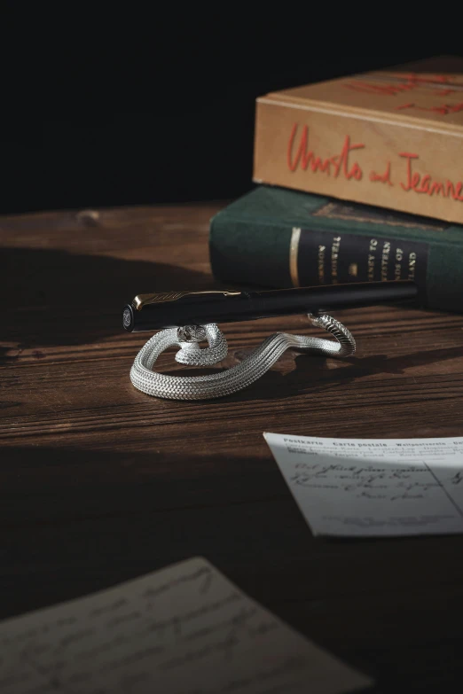 some books and a pen sitting on a table