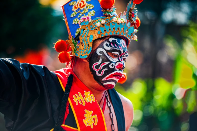 a man with a painted face has his hand on his hip