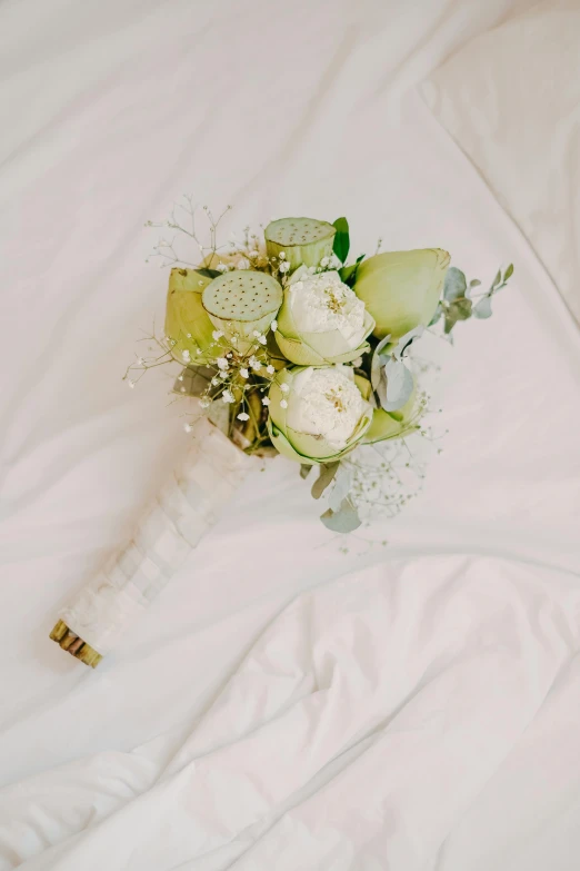 a bridally arranged white and green wedding bouquet