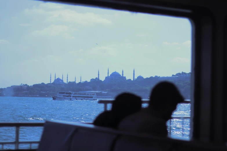 the view from inside the boat shows buildings and boats on water