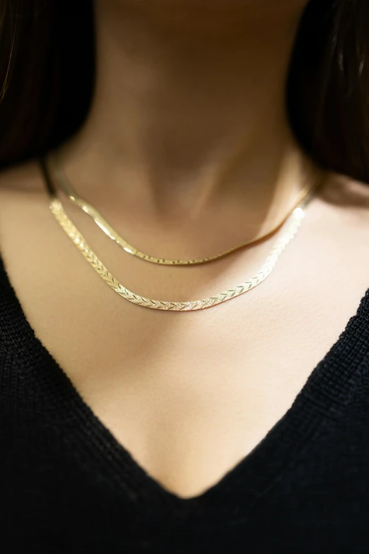 close up view of a woman wearing a gold necklace