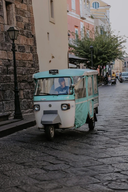 the man is driving his vehicle on the street