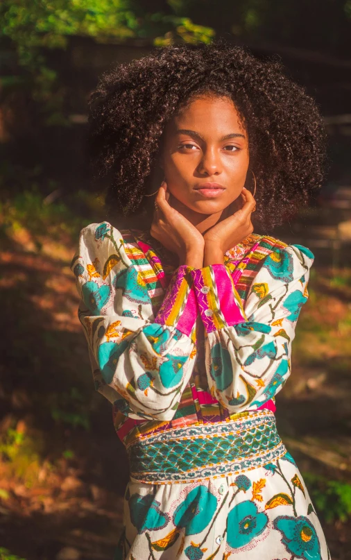 a young woman poses in a beautiful flowered dress