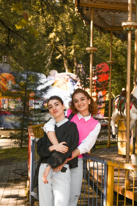 a young lady on the merry go round with a friend