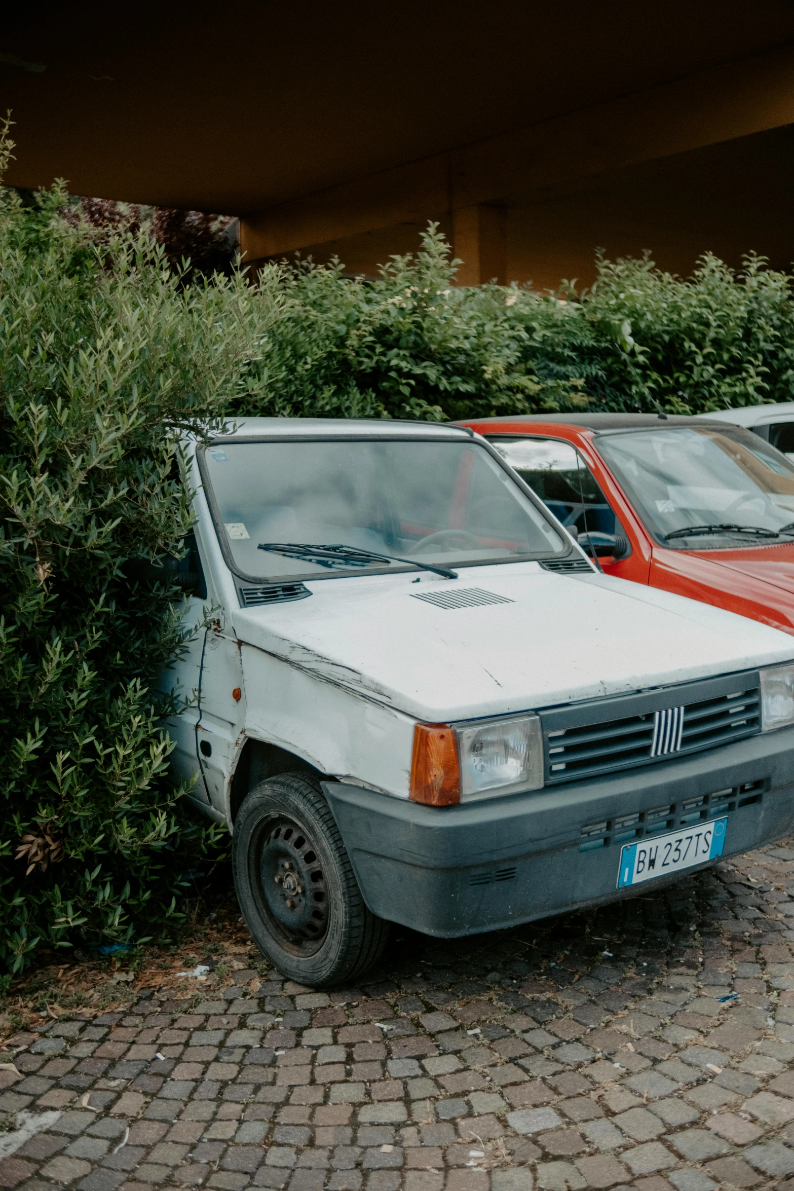 three old cars sitting in a parking lot