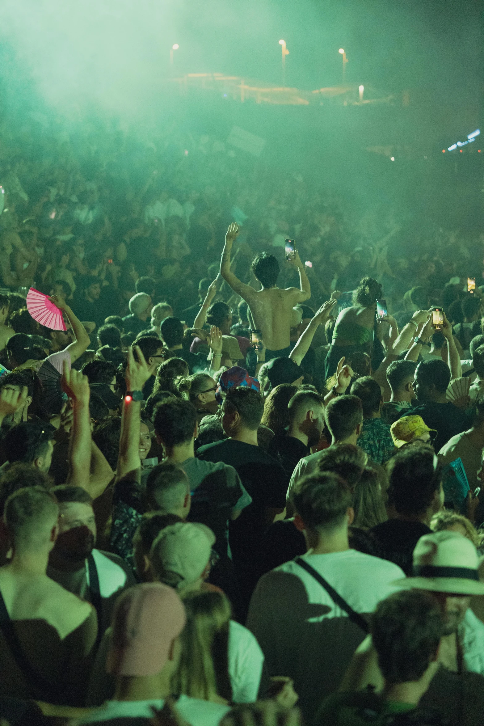 a man in the crowd waving in front of a microphone