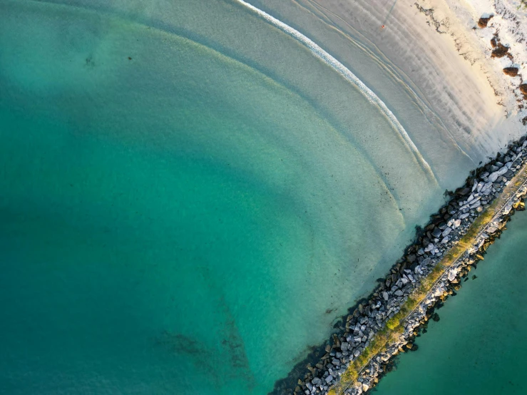 an aerial view of a beach and a long road