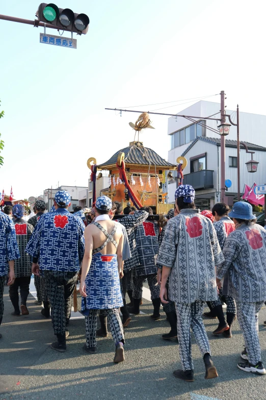 a group of people are walking in the street