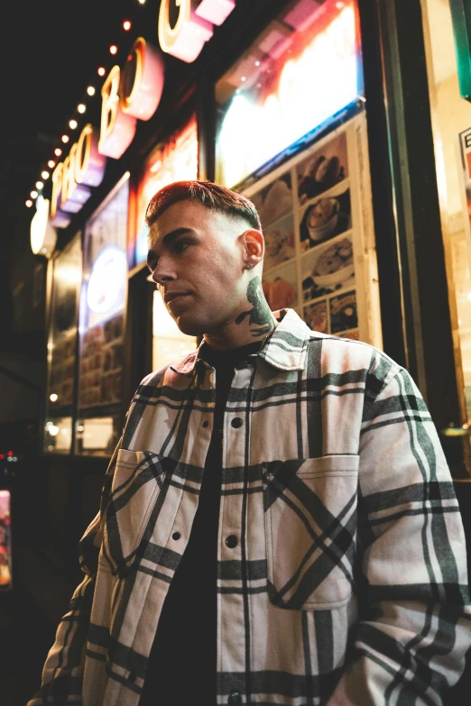 a man in a coat looking down while standing outside