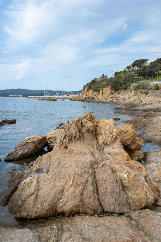 some rocks and water near a beach