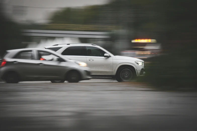 a couple of cars that are parked in the rain