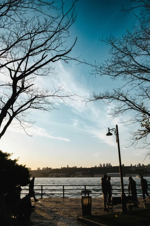 people walking along the water in a city