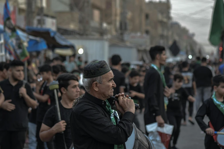 a man walking on the street while holding onto some flags