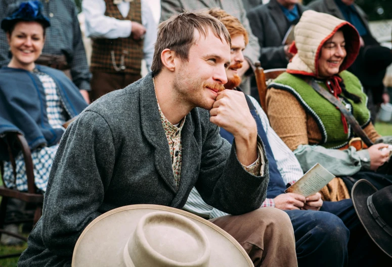 a man eats some type of food at a festival