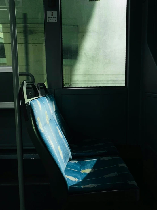 a sleeping chair with a blue cover is in the dark