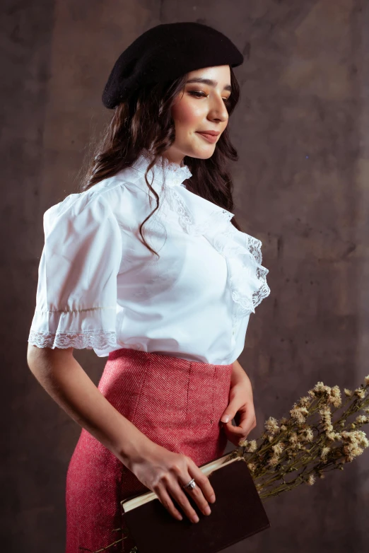 a woman in a dress holding a book