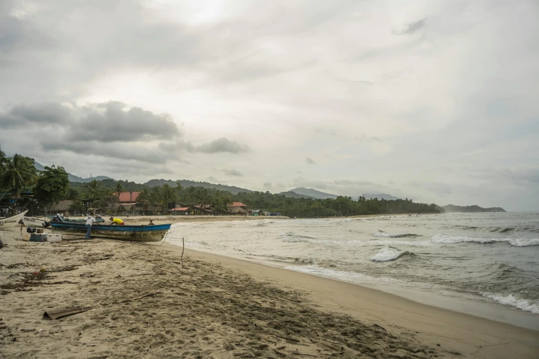 two boats docked on the shore of a beach