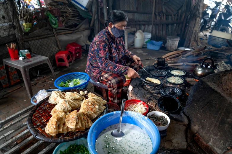 a woman cooks food in her home made kitchen