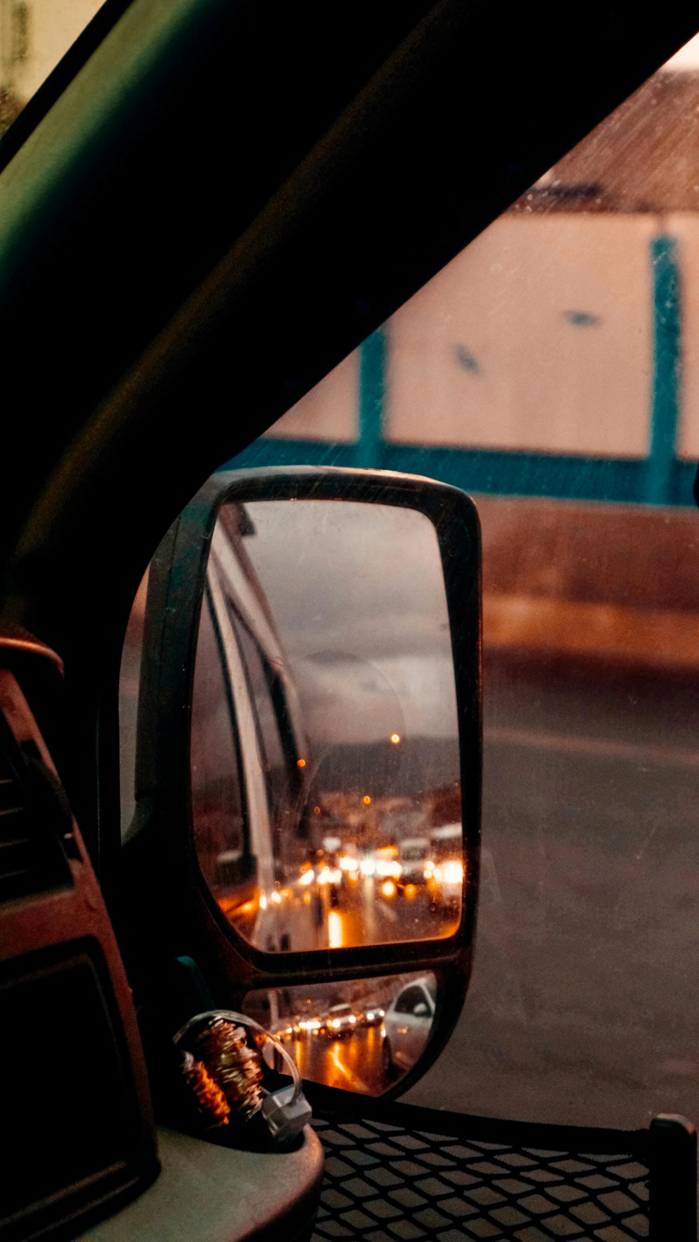 the inside of a car looking at the side mirror