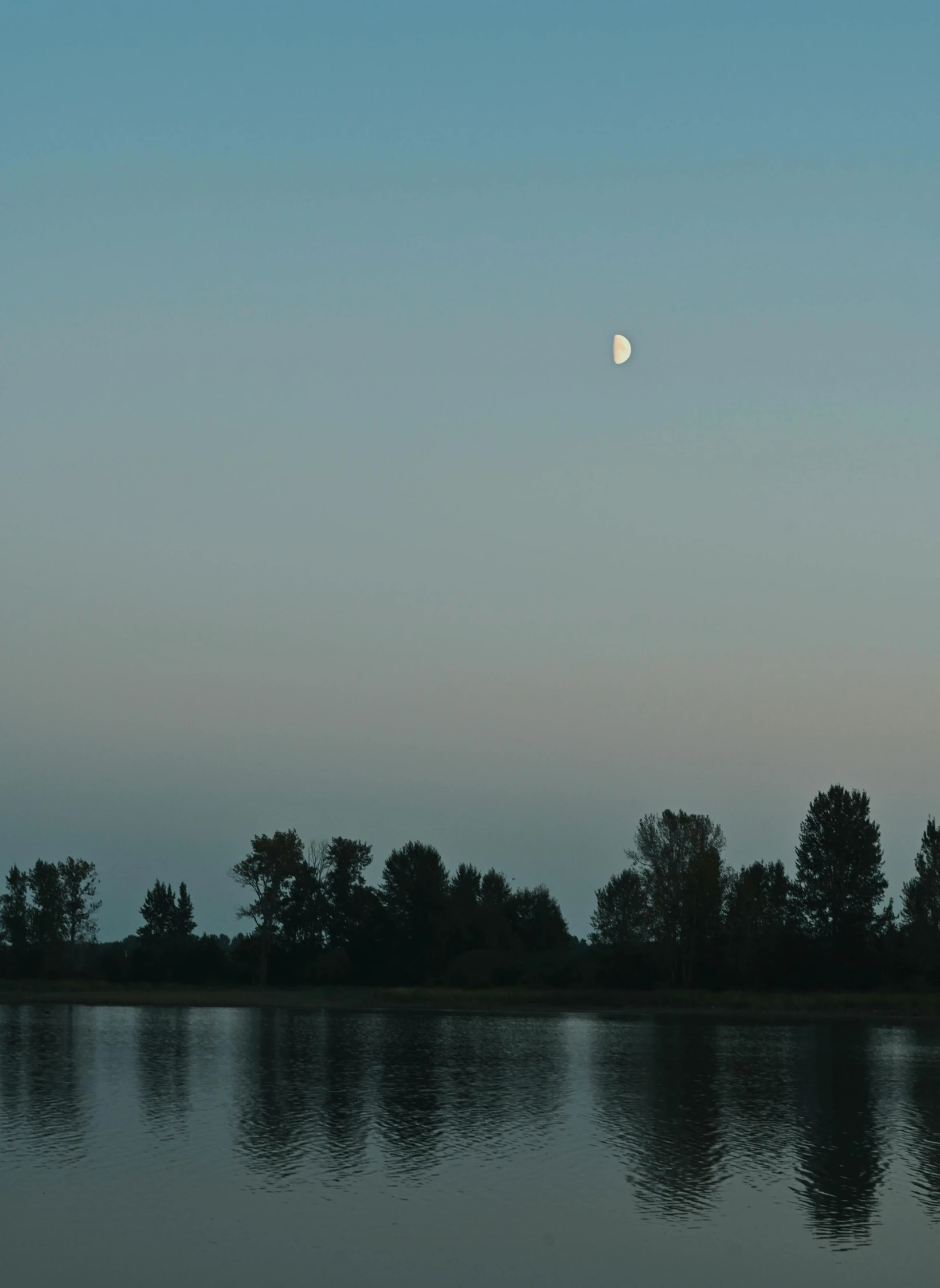 the moon is seen reflected in the water