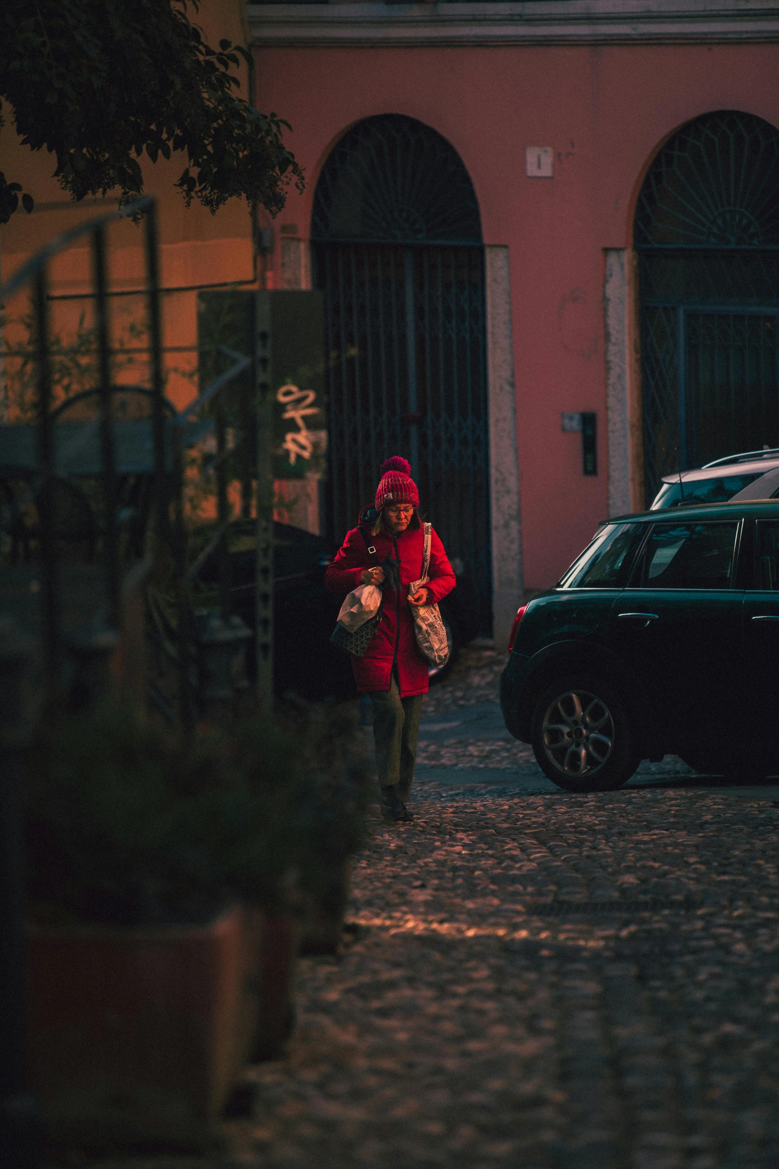 a person walking down a street next to a building