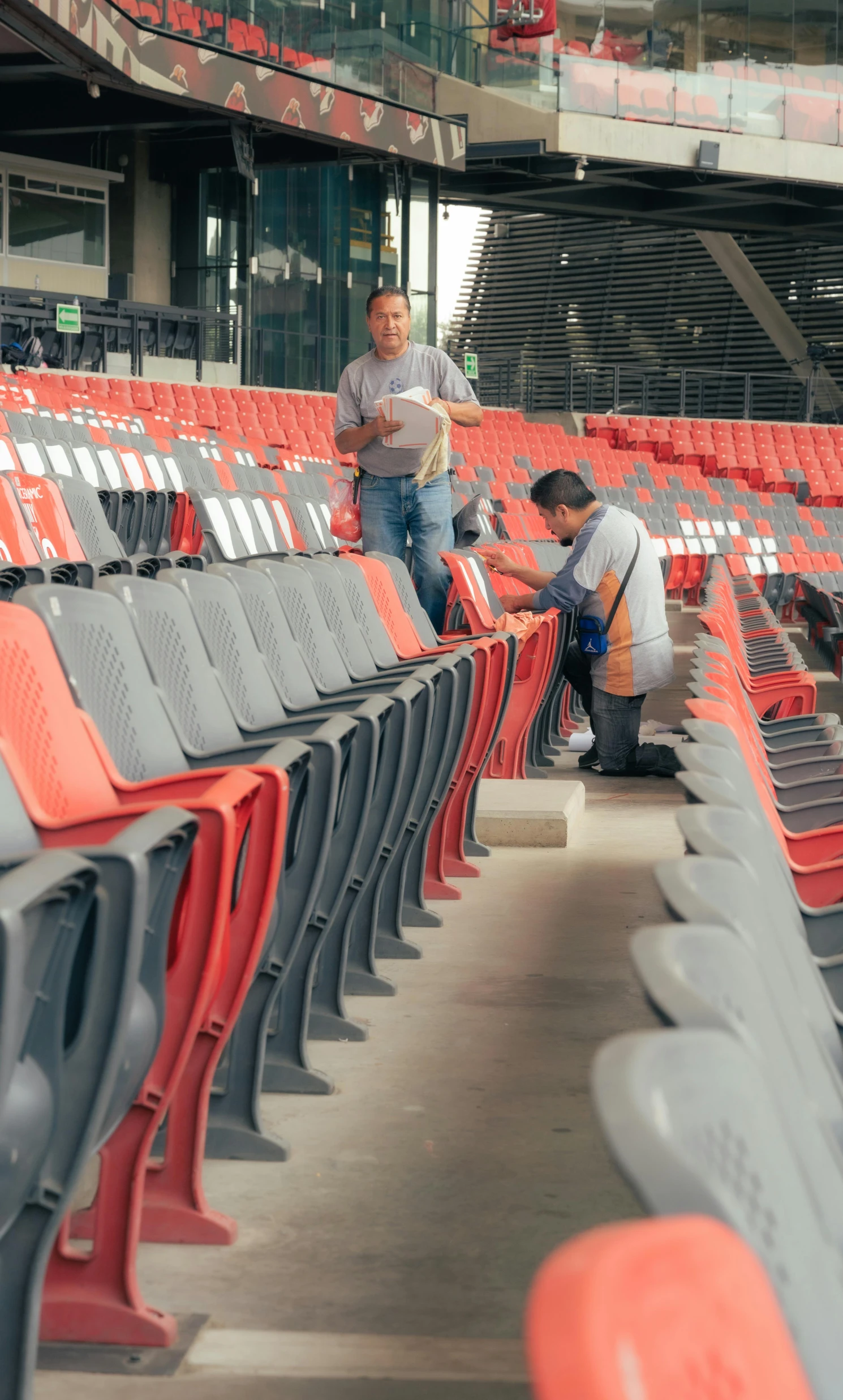 a man that is kneeling down at some chairs