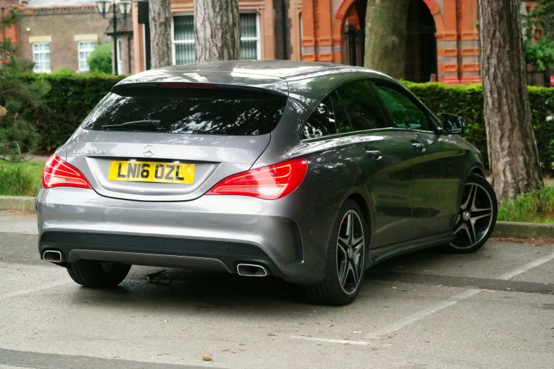 a mercedes benz cla car is parked at the curb