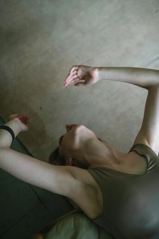 a person laying on a bed near an open book