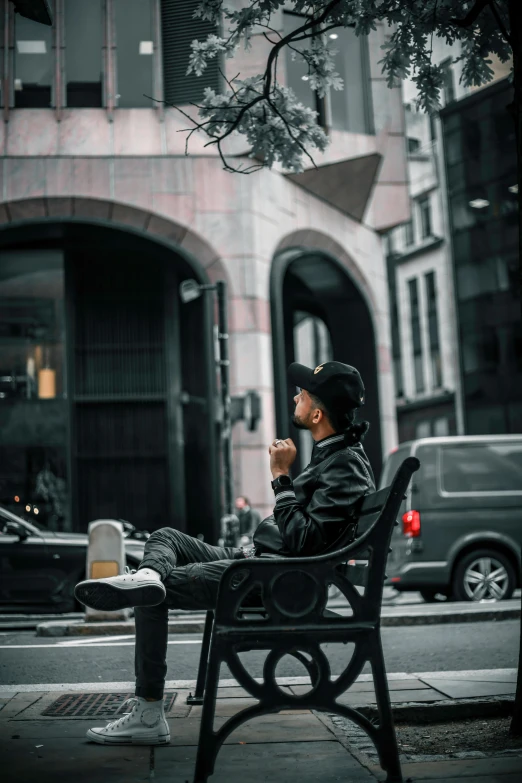 a man sitting on a bench with his foot propped up