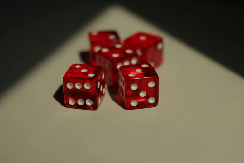 five red dice laying on top of a table