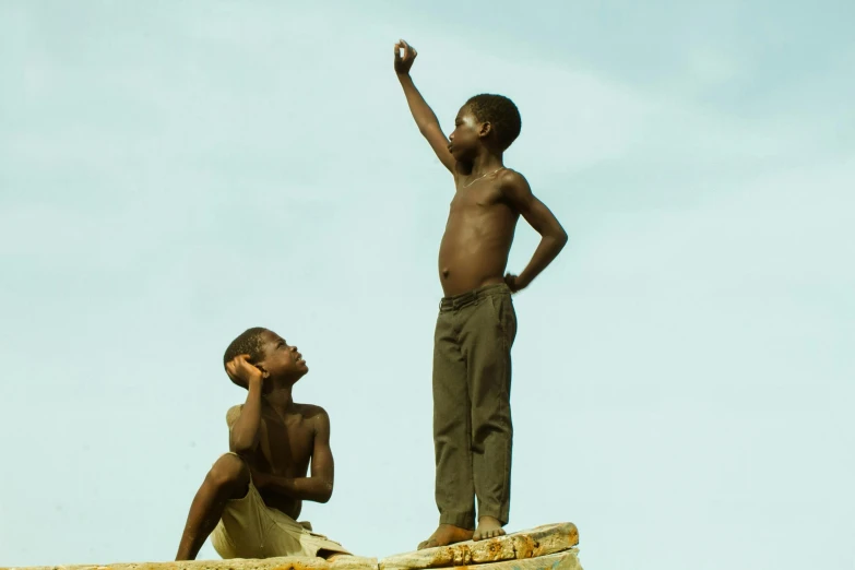 two s standing next to each other on top of a brick building