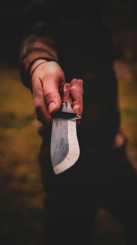 a person holding an old knife in their hands