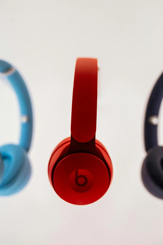 three headphones that are red and blue in color