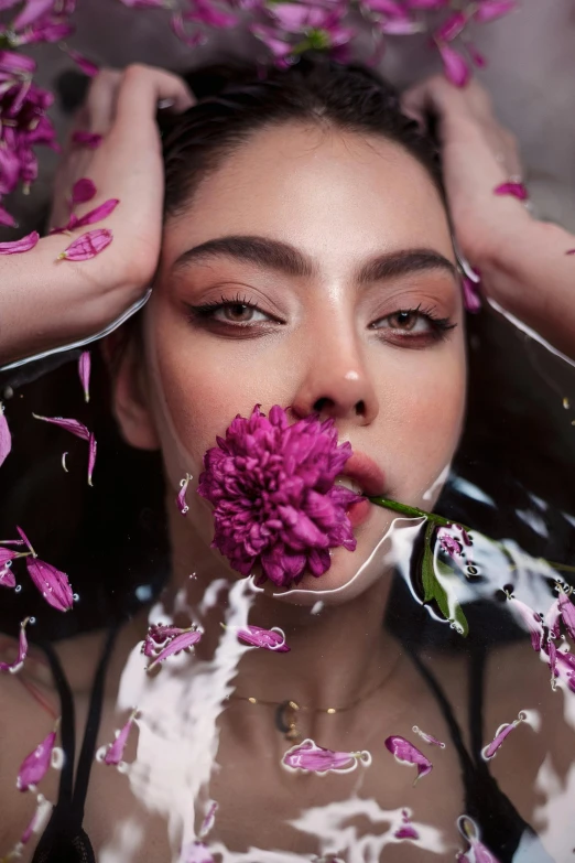 a girl in wet - looking water with flowers