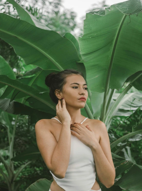 a woman is touching her neck and smiling