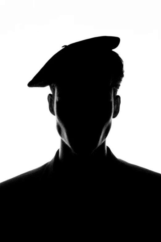 black and white po of man wearing hat with open back