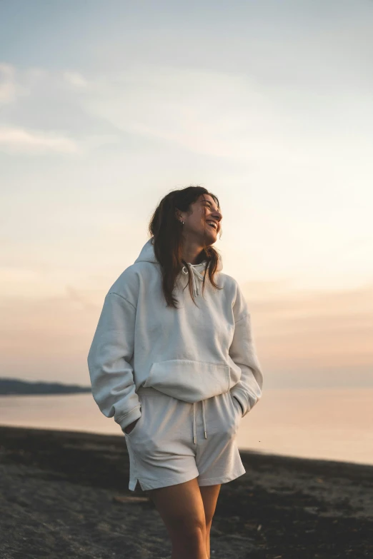 a person standing on the beach with their feet propped up