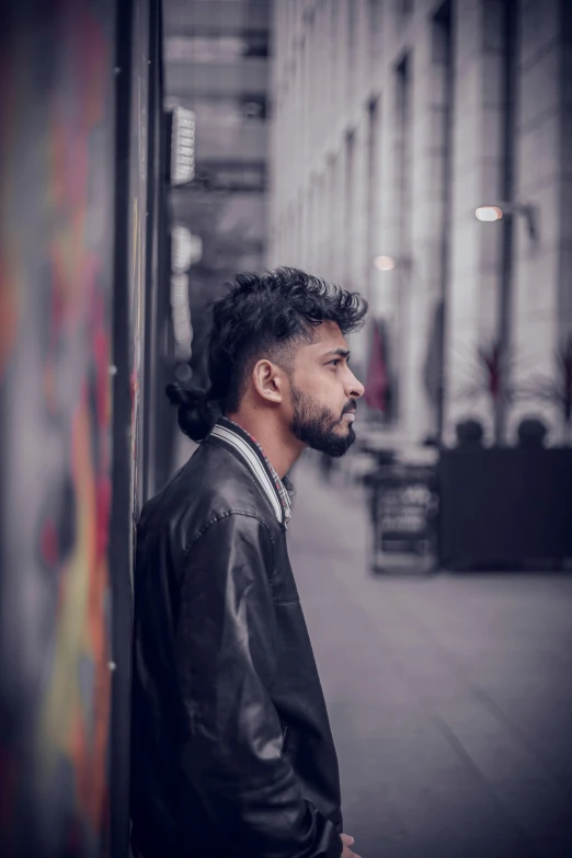 the man is looking ahead as he stands on a city street