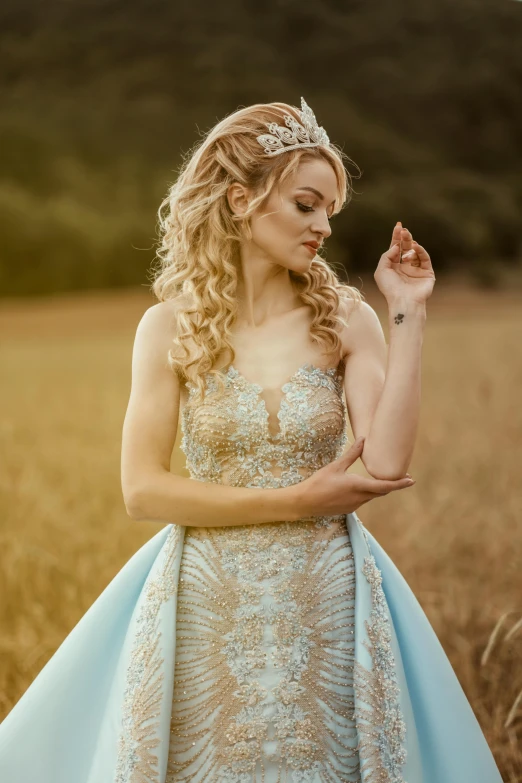 a woman in a blue dress poses for the camera