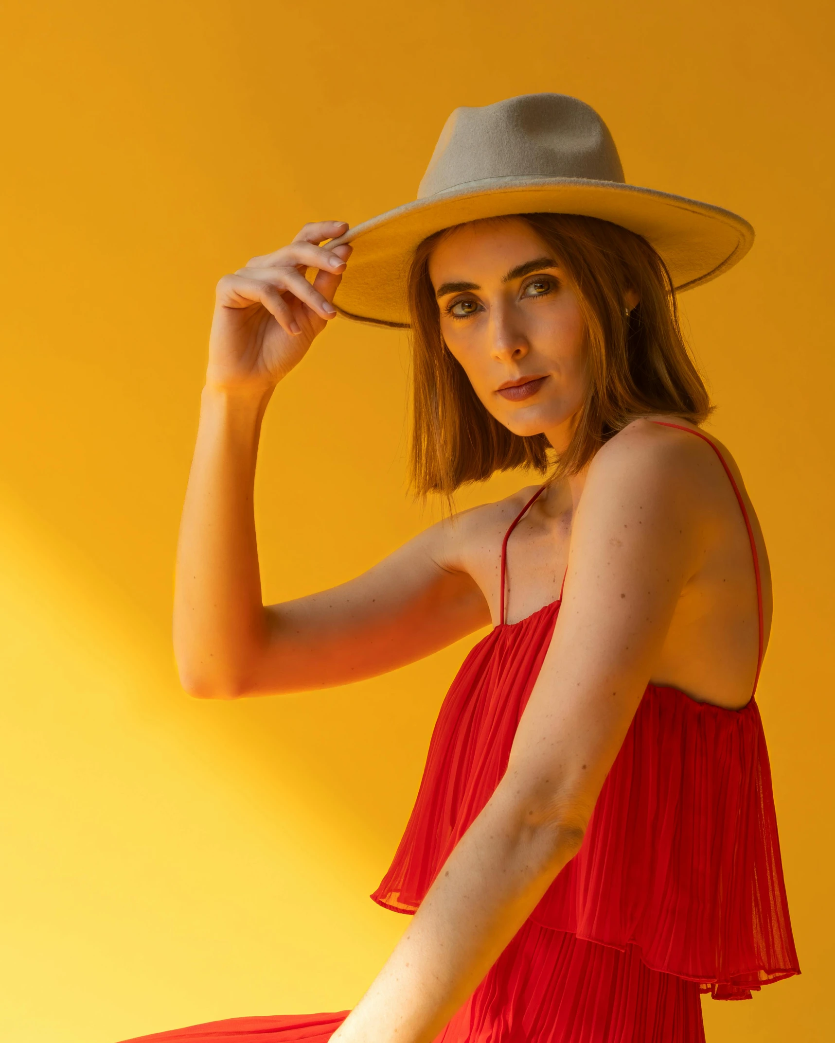 an attractive woman with long hair wearing a sun hat