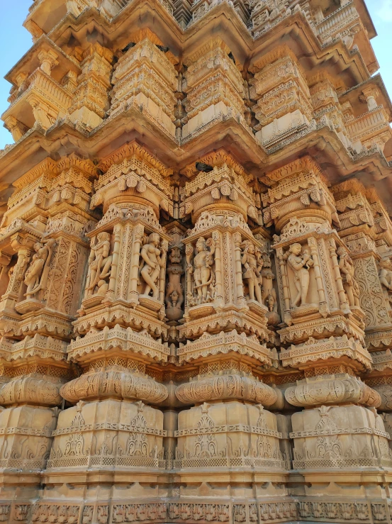 a tower with decorative sculptures on it's side