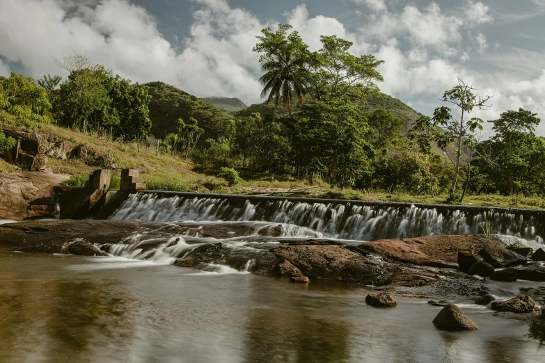 a stream flows over rocks into a large lake